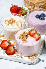 sweet yogurts with fruit and berries for a delicious breakfast, vertical top view
