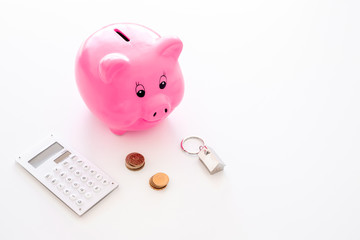 Mortgage. Savings for buy house. Moneybox in shape of pig near keychain in shape of car, coins, calculator on white background copy space