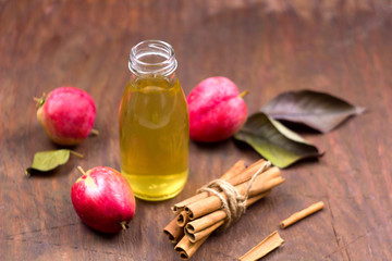 fresh apple drink in a glass bottle wooden background