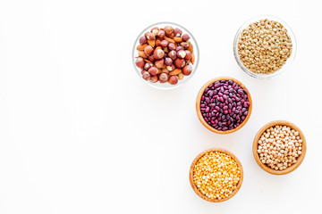 Vegan protein source. Legumes and nuts on white background top view copy space