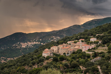 Fototapeta na wymiar Stormy sunrise over village of Costa in Corsica