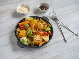 Vegetables roasted on the grill. Baked corn with vegetables. Rustic food.