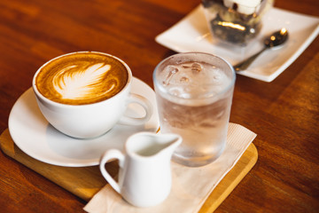 Latte coffee cup on wooden table.