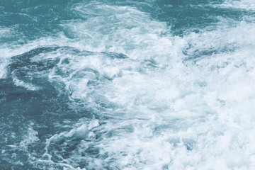 Fototapeta na wymiar Abstract natural blue sea water background with white foam