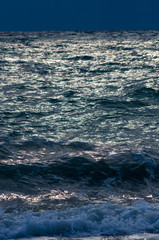 sea landscape is a pebbly beach with waves in white foam