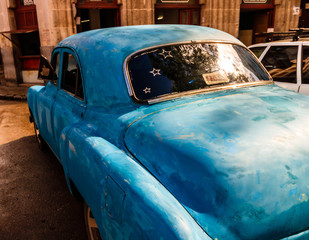 Blue american car parked on the streets of Havana. Old blue paint job on a vintage car.