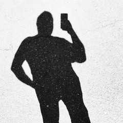 Shadow of a person using a smartphone, mobile, phone,
