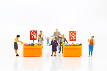 Miniatrue people: Shoppers buy goods on sale with discount tray. Tourism, shopping or business concept.