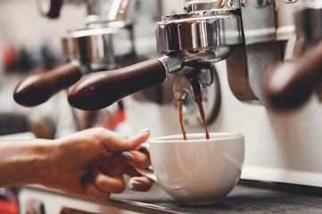 Coffee extraction espresso from professional machine and barista with filter