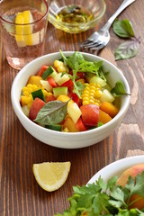 Salad with sweet corn, cucumber, sweet pepper and peach with ingredients, vertical