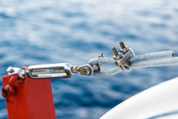 Turnbuckle securing life raft on a construction barge at oilfield
