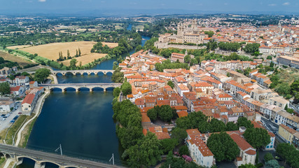 Aerial top view of Beziers town, river and bridges from above, South France
