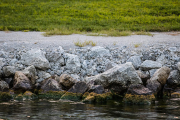 Fototapeta na wymiar Mossy Rocks at the Lake
