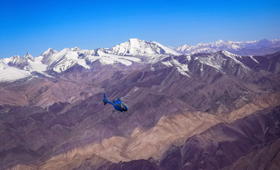 Tourist helicopter flies across the Himalayan range at Ladakh India.  © Roop Dey