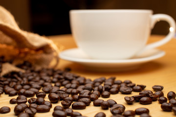 Coffee bean with blur coffee cup.