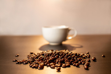 Coffee bean with blur coffee cup.
