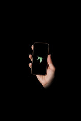 Unicorn - A hand, a black phone on a black background © dmytrobandak