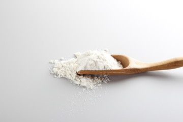 flour spoon spatula on a light background