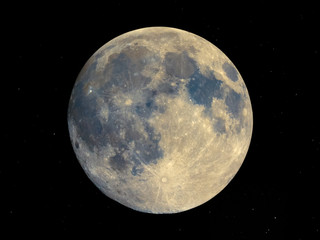 Full moon seen with telescope, starry sky