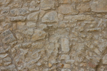 Ancient wall of the medieval city, the wall of an ancient temple in Prague, stone masonry test with cement, blank for designer, retro background