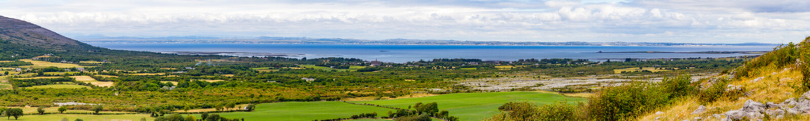 Fototapeta na wymiar Galway bay with Farm field, mountain and vegetation in Ballyvaughan