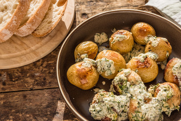 Swedish food - traditional chicken meatballs with cream sauce and new potatoes on a rustic wooden background, top view, copy space