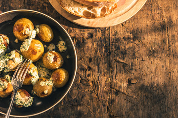 Swedish food - traditional chicken meatballs with cream sauce and new potatoes on a rustic wooden background, top view, copy space