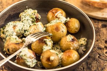 Swedish food - traditional chicken meatballs with cream sauce and new potatoes on a rustic wooden background, top view