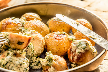 Swedish food - traditional chicken meatballs with cream sauce and new potatoes on a rustic wooden background, top view