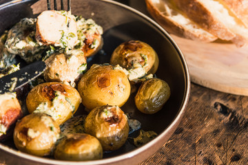 Swedish food - traditional chicken meatballs with cream sauce and new potatoes on a rustic wooden background, top view