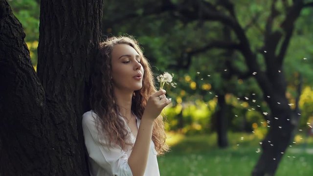 Woman Blow on a Dandelion