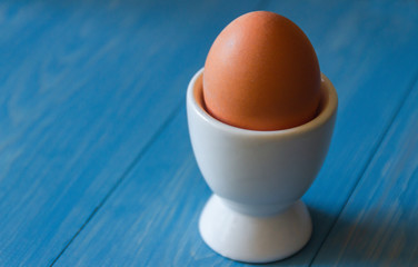 Boiled egg in white egg cup