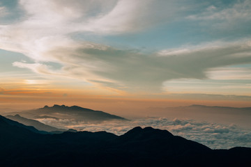 Fototapeta na wymiar hiking above the clouds while sunrise
