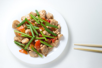 Homemade kung pao chicken on white background