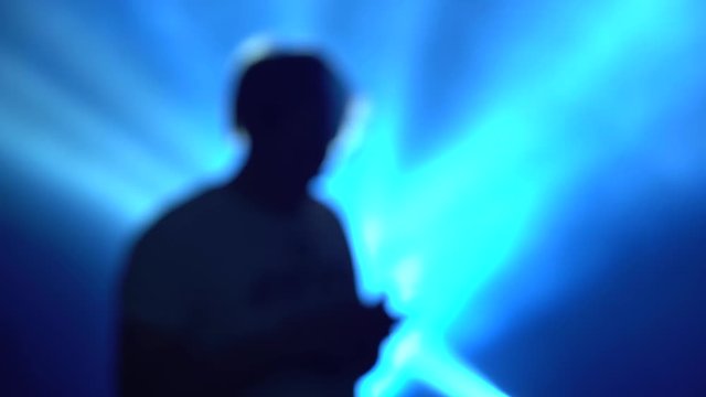 Man with a mobile phone on a disco light background