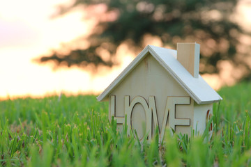 Image of vintage house in the grass, garden or park at sunset light.