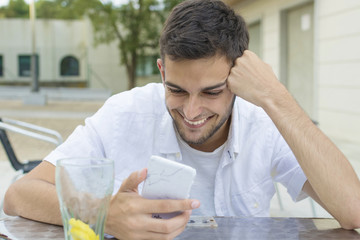 young or young adult smiling with the outdoor mobile phone in the cafeteria