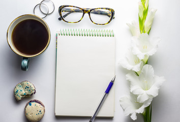 Stylized feminine flatlay with glasses, lipstick, and tablet mock up isolated on white top view.