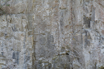 The background of a smooth stone wall of the mountain
