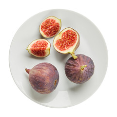 Fresh raw ripe figs in ceramic plate isolated on white background. Ingredients for cooking. Top view.