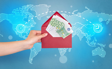 Female hand holding coloured and white envelope with blue map on the background
