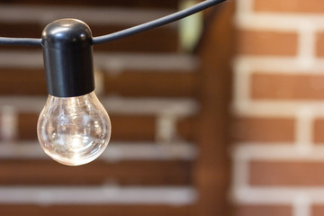 One old bulb hanging from the ceiling close-up