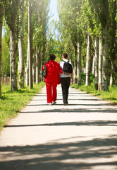 Fototapeta premium Mother and child walking together in summer city park