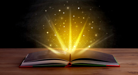 Yellow lights and sparkles coming from an open book 