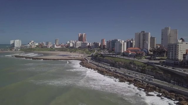 Rambla Patricio Ramos at Playa Varese on the coast of Mar del Plata Argentina – 4k drone video of the Argentinian coast Mar del Plata Casino Central in spring.  Buenos Aires Capital Federal district  