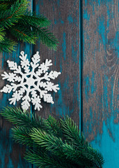 Snowflake christmas tree toy on wooden rustic desk. Christmas decoration.