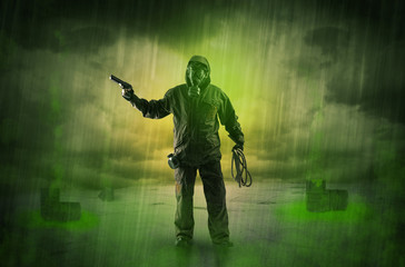 Fototapeta premium Masked unrecognizable guard in an abandoned space after explosion 