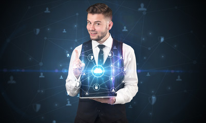 Secured cloud hologram on tablet  holded by spectacled young businessman in suit
