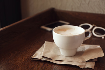 Cup of fresh aromatic coffee on table
