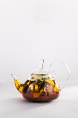 Winter tea with cinnamon, lemon, honey in a teapot isolated on white background.